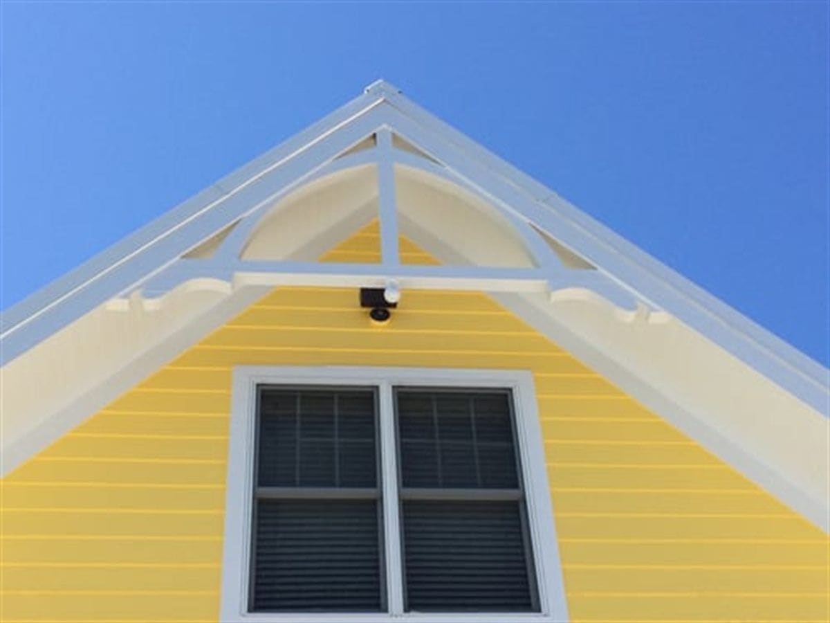 Weathered exterior siding and trim on a home showing paint failure