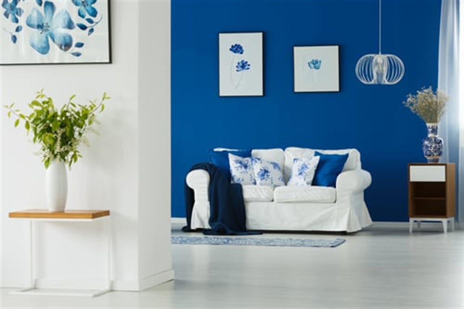 Freshly painted living room with a deep blue accent wall in an Omaha home
